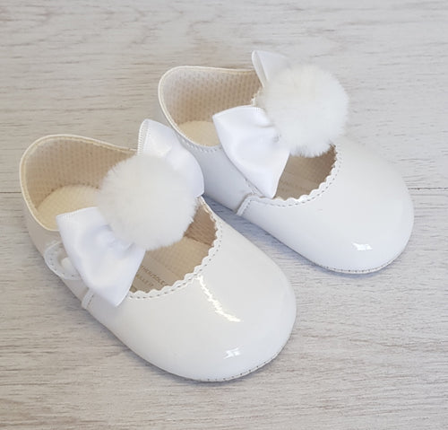 White patent bow/pompom soft sole shoes