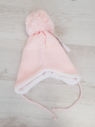 Pink tie under pompom hat