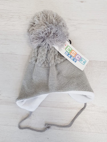 Grey tie under pompom hat