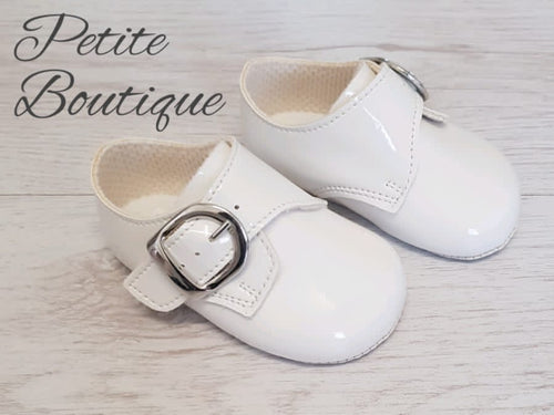 White patent buckle over soft sole shoes