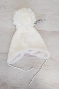 White tie under pompom hat