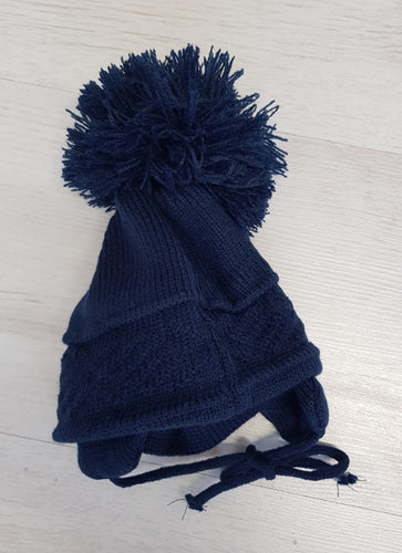 Navy tie under pompom hat