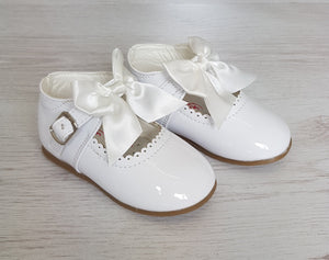 White patent bow shoes
