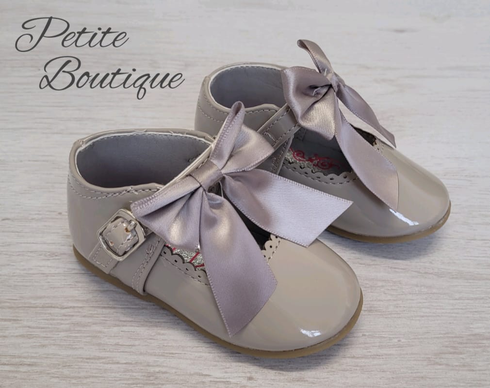 Grey patent bow shoes