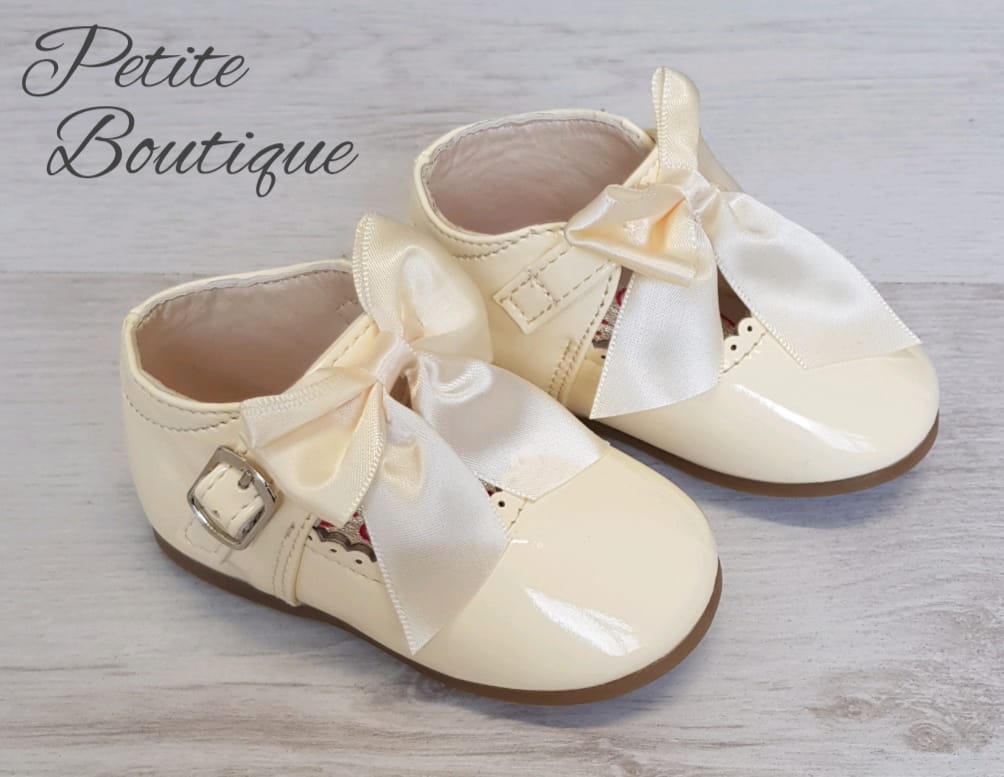 Cream patent bow shoes